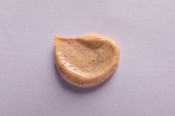 Sample of scrub on lilac background, top view