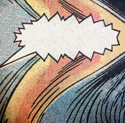 Closeup photo of a real vintage comic book page with empty speech bubble and yellow red and blue printing dot pattern - 551951261