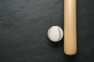 Baseball bat and ball on black background, top view with space for text. Sports equipment