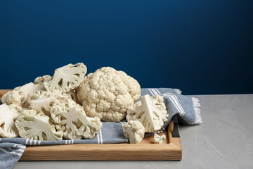 Fresh raw cauliflower on light grey table. Space for text
