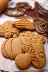 Tasty cookies and cutters on table, closeup