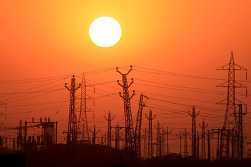 Electricity towers against the sunset in Rajasthan state, India