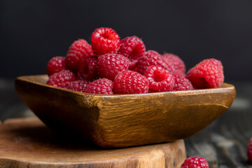 The harvest of red ripe raspberries is on the board