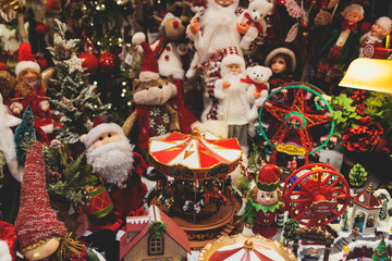 Christmas market details with New Year decorations and multicolored flags, garlands and festoons, Xmas atmosphere, fair interior, retail and store with illumination, New Year glowing decor