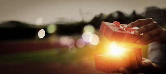 He opened a wonderful gift box for his lover.Concept merry christmas and happy new year 2022 , 2023...