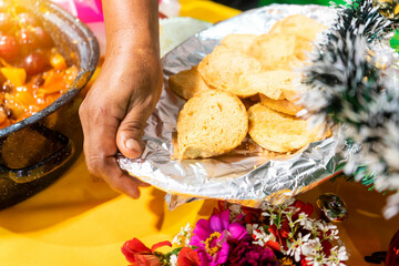 Hands of an elderly Latin woman serving bread during Christmas dinner