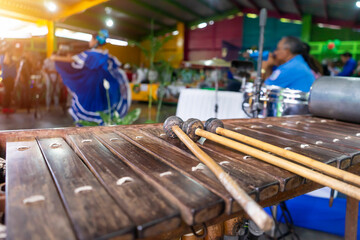A marimba in the foreground while a dancer in traditional dress performing typical Nicaraguan dances
