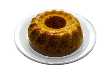 Unmoulded carrot cake on a white plate.