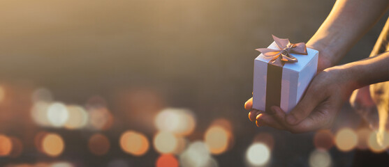 Females holding Christmas gift box decorated with Christmas and New Year banner Concept merry christmas and happy new year 2022 , 2023, 2024