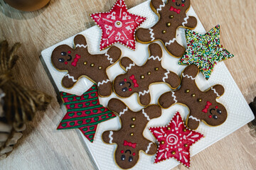 Gingerbread cookies on the plat in the hand and in the tree ready for christmas and for kids to eat holiday cookies handmade baked gingerbread cookie