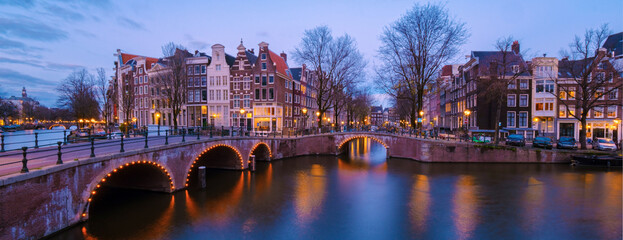 Amsterdam Netherlands canals with lights during the evening in December 