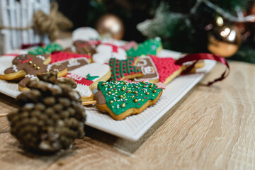 Gingerbread cookies on the plat in the hand and in the tree ready for christmas and for kids to eat holiday cookies handmade baked gingerbread cookie