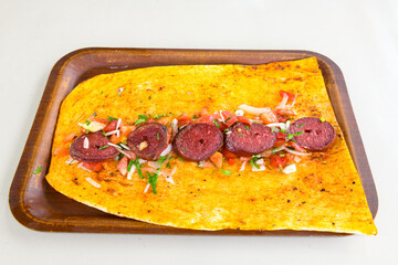 Close-up shot of Izmir's famous Turkish Traditional Kumru Sandwich, Çeşme Kumru , ingredients ready to eat salami, sucuk , tomato, cheddar cheese and fried cheese. Yengen eritme karisik sandvic.