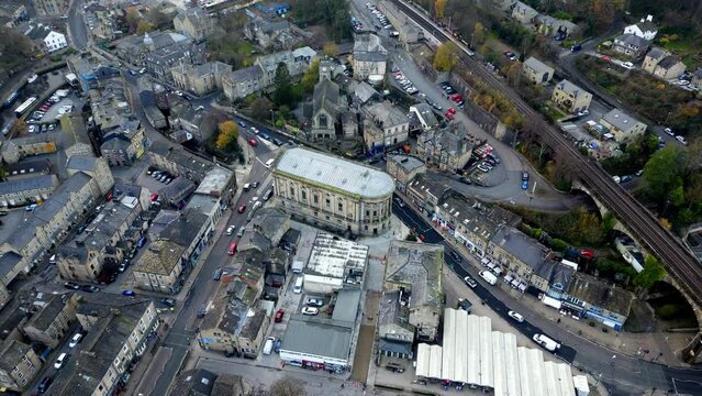A drone hyperlapse of todmorden town hall in calderdale in north of england , rushing traffic and old buildings 