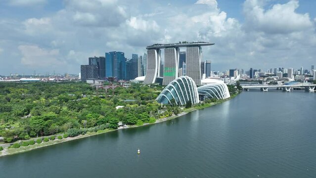 Singapore drone pull away shot over the Marina Bay, looking at Marina Bay Sands and Botanical Garden Flower Domes