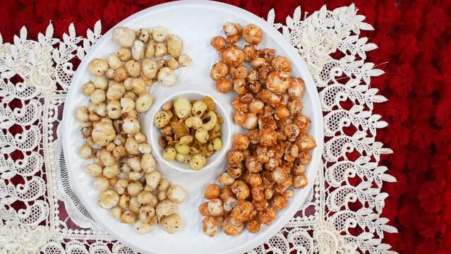 Crispy, healthy and homamade Phool Makhana or Fox Nuts snacks platter. It contain caramel makhana with jaggery, with sugar and Makhana mixture having peanut and cornflakes. Zoom video