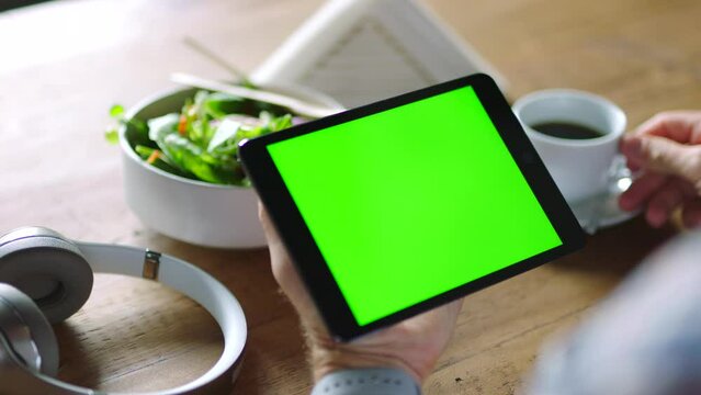 Green screen, tablet and hands of a business person with coffee, marketing space and digital branding on tech. Advertising website, company logo and employee with lunch and technology for mobile app