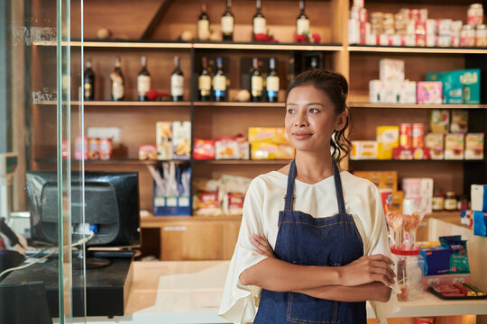 Worker Standing at Grocery Shop Counter