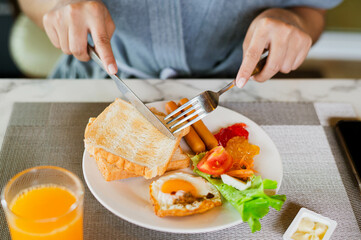 Closeup on a young woman she is having breakfast.