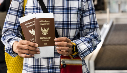 Tourist showing passports and boarding ready to going abroad, Tourist Vacation Concept
