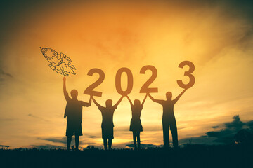 Happy new year 2023 background new year holidays card with bright sunlight, family with arms raised new year 2023.