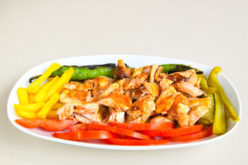 Turkish and Arabic Traditional Ramadan doner kebab with tasty tomato sauce and rice or turkish pilav in white plate on wood table background. ( Pilav ustu doner)