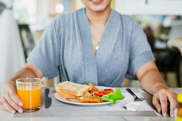 Closeup on a young woman she is having breakfast.