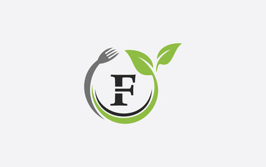 Green leaf food logo with spoon and healthy logo design image spoon fork and leaf