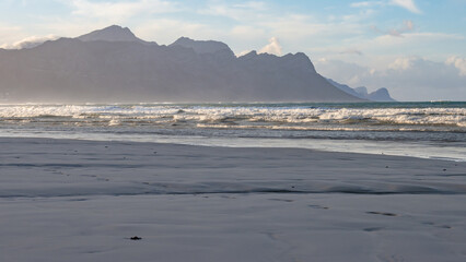 Fototapeta na wymiar Mountain range behind Strand Beach with sea sand foreground