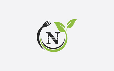 Green leaf food logo with spoon and healthy logo design image spoon fork and leaf
