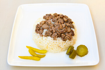 Traditional turkish bulgur pilaf with tomato sause in plate (Turkish name; bulgur pilavi, meyhane pilavi) Pirinc pilavi. Pilavustu tavuk, nohut, kuru fasulye, ciger.