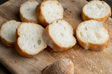 Sliced wheat baguette on a board