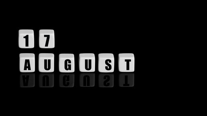 August 17th. Day 17 of month, Calendar date. White cubes with text on black background with reflection. Summer month, day of year concept