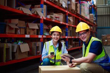 Asian female, male workers in warehouse with construction products. holding bar code scanner and...