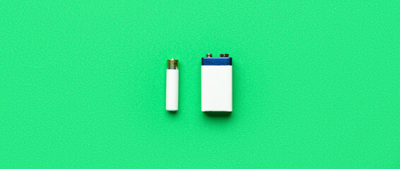 Alkaline batteries on green background