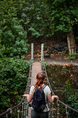 Female tourist in Tbilisi botanical garden. Rainy day in Tbilisi botanical garden. Tbilisi, Georgia
