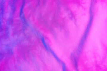Purple fabric surface in neon light as background