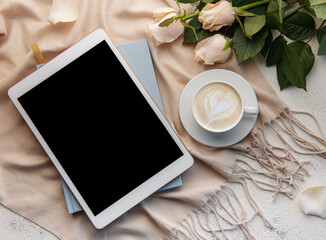 Top view a cup of coffee latte art heart shape with a pink rose and tablet