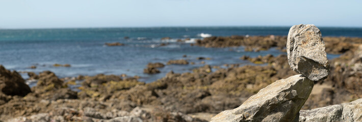 Stone rock balanced on another rock, persistence, calm, patience, banner concept