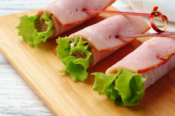 Meat rolls in plate on banquet table