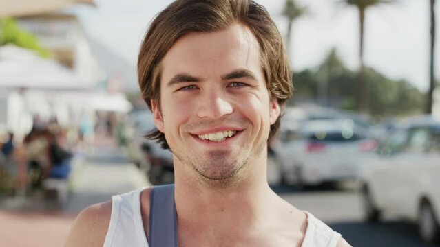 Summer, travel and face of man with smile enjoy holiday, vacation and relax on weekend in Miami. Spring break, fashion and portrait of young male in city street ready for adventure, freedom and fun