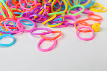 Fototapeta premium Colorful rubber bands on light background, closeup