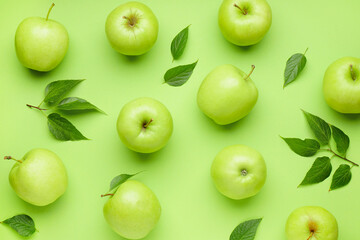 Juicy ripe apples on green background