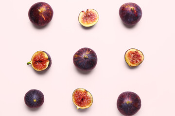 Whole and cut fresh figs on pink background