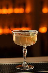 Daiquiri cocktail with rum and lime juice on the bar in a pub or restaurant.