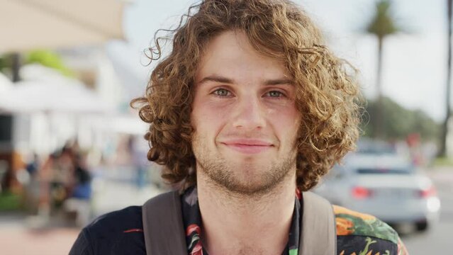 Face, man and smile portrait in city for travel holiday, summer vacation or gen z person on sidewalk. Happiness, positive mindset and confident male headshot in Cape Town street for relax freedom