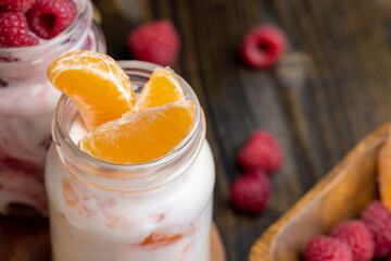 Milk yogurt with tangerine, close up
