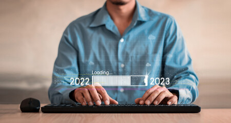 Countdown to 2023 concept. the taps a virtual download bar with a loading progress meter on New...