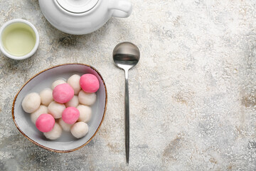 Bowl of tangyuan, cup and teapot on grunge background. Dongzhi Festival