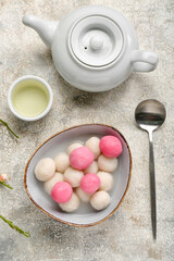 Bowl of tangyuan, cup and teapot on grunge background. Dongzhi Festival